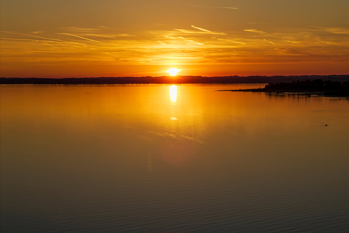 Panoramic Chiemsee lake view during sunset phase after an amazin